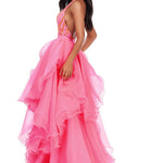 Woman wearing a pink evening gown on a white background
