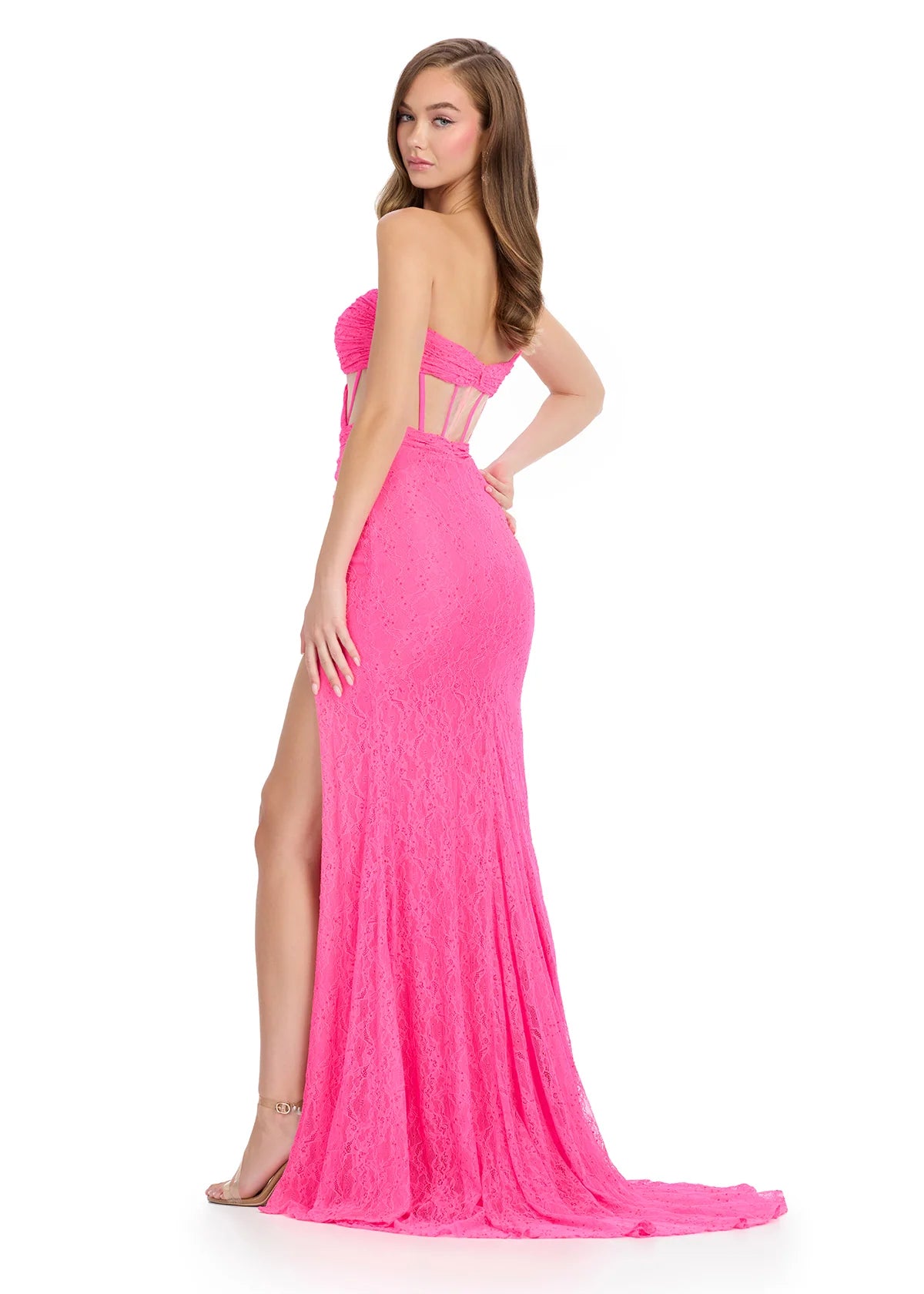 Pink evening gown with cut-out design and high slit on a white background