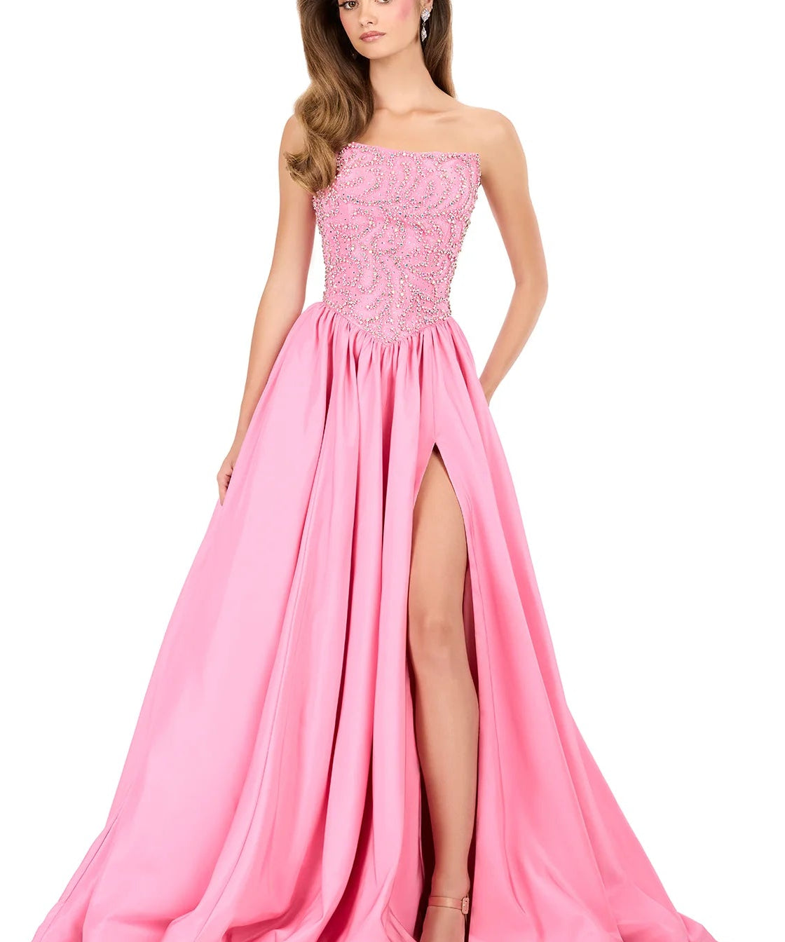 Pink evening gown with a slit on a white background