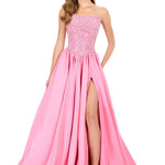 Pink evening gown with a slit on a white background