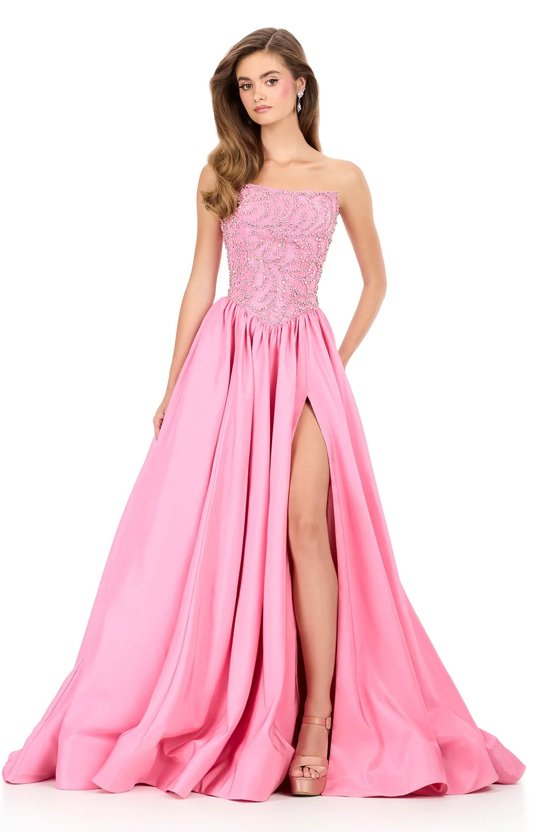 Pink evening gown with a slit on a white background