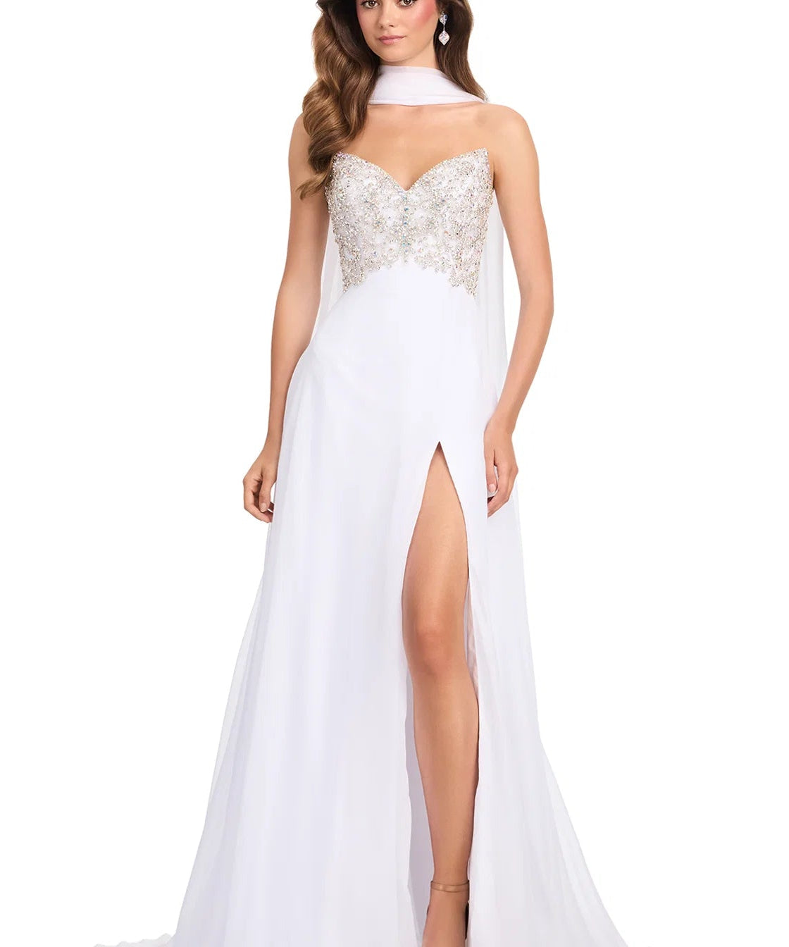 Woman wearing a white evening gown with a high slit on a white background