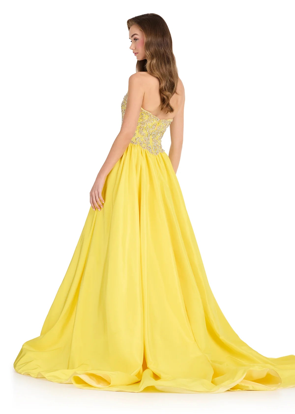 A woman modeling a strapless yellow ball gown with a beaded bodice, shown from the back against a plain white background.