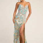 A woman modeling a strapless floor-length evening gown covered in shimmering sequins and beads. The dress has a sweetheart neckline, a high thigh slit, and a slight train, shown against a plain light beige studio background.