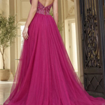 Pink evening gown with open back in an elegant interior setting