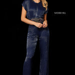 A woman modeling a dark navy blue beaded jumpsuit with a beaded waistband, photographed against a solid black background. The brand name 'SHERRI HILL' is printed on the right side.