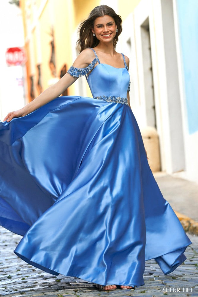 Woman in a blue evening gown with a cityscape background