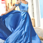 Woman in a blue evening gown with a cityscape background