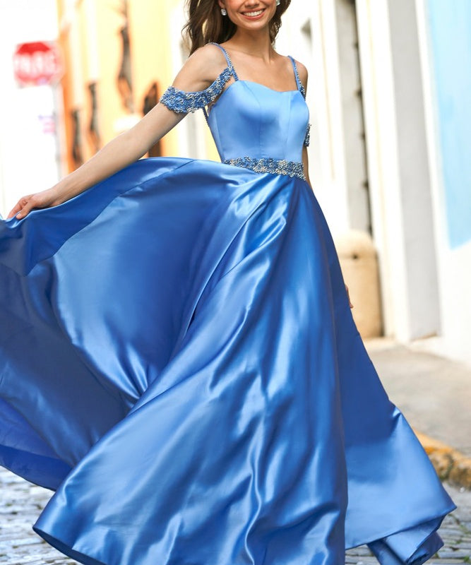 Woman in a blue evening gown with a cityscape background