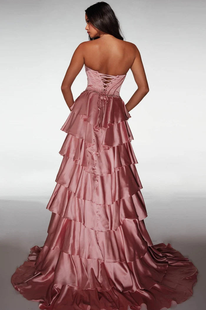 Pink evening gown with tiered layers on a plain background