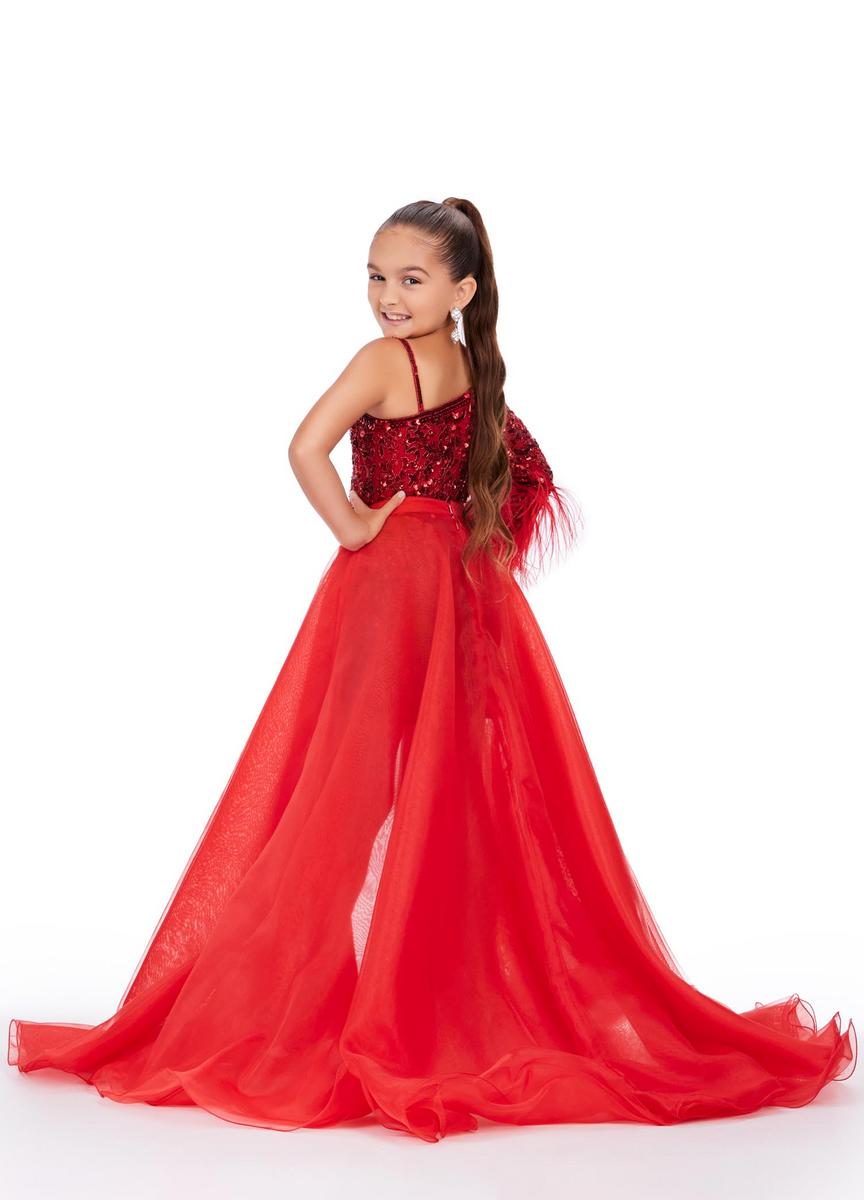 Young girl wearing a red evening gown with a white background