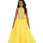 Girl wearing a yellow dress with a white background