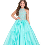 Girl wearing a turquoise gown with a white background