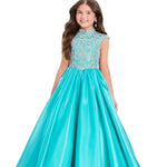 Girl wearing a turquoise evening gown with beaded top on a white background