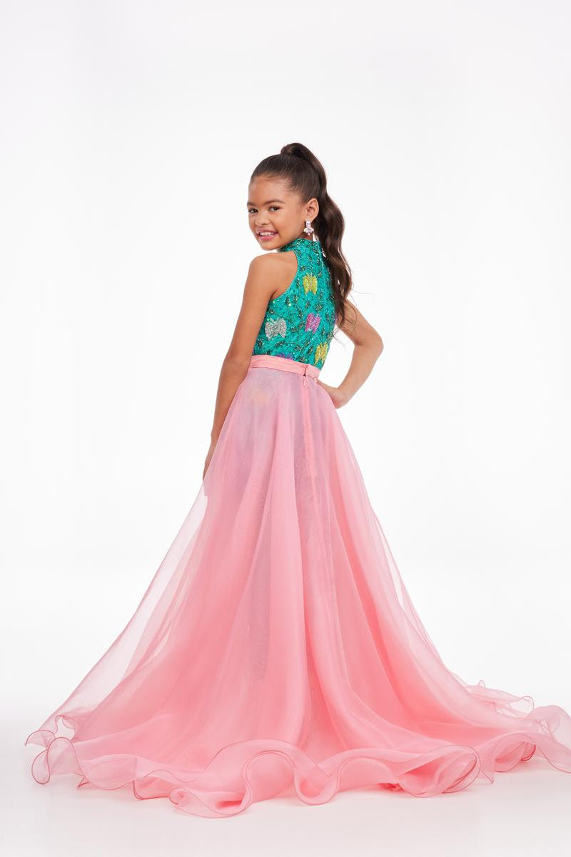 Young girl in a pink and teal formal gown on a white background
