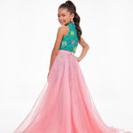 Young girl in a pink and teal formal gown on a white background