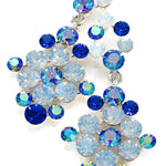 Decorative crystal earrings made of blue and clear opal gemstones on a white background