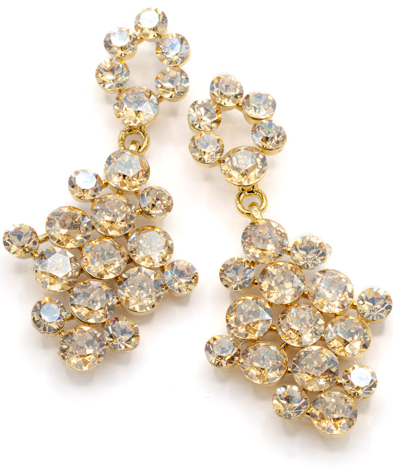 Gold earrings with clear gemstones on a white background