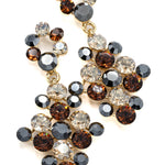 Elegant earring with multicolored animal print gemstones on a white background