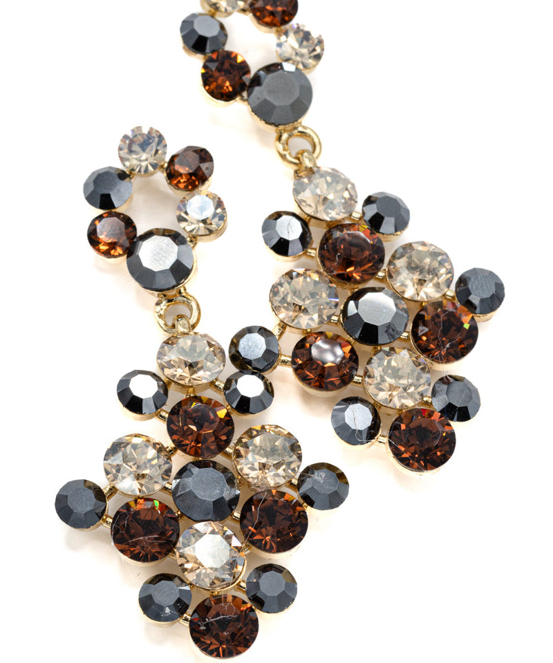 Elegant earring with multicolored animal print gemstones on a white background