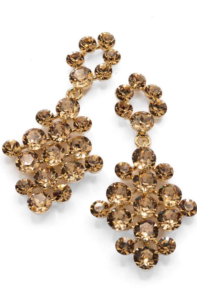 Pair of gold crystal earrings on a white background