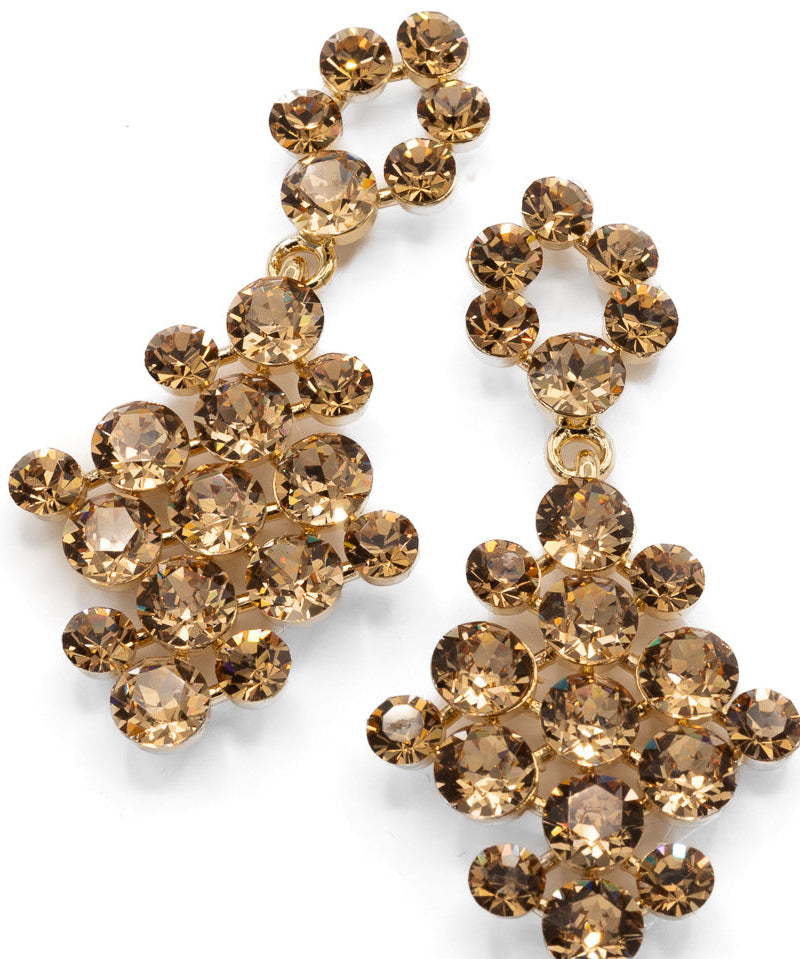 Pair of gold crystal earrings on a white background