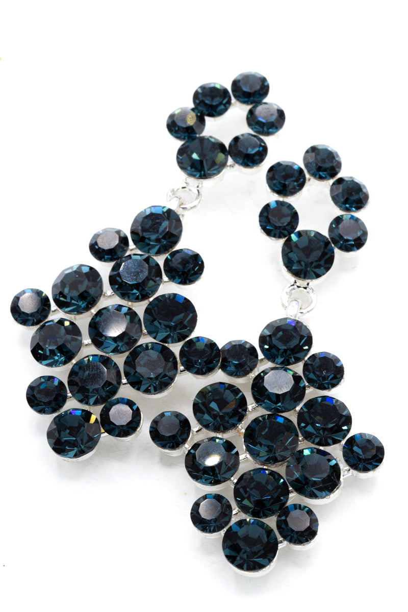 Pageant/Formal earrings with blue gemstones on a white background
