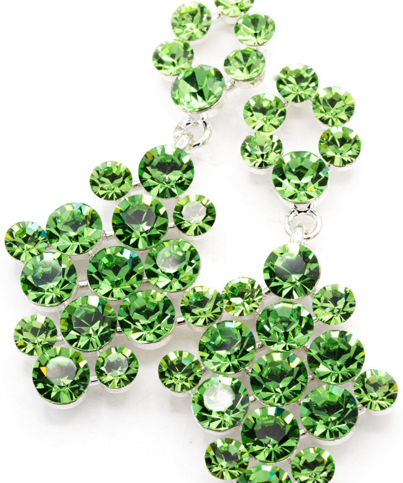 Green gemstone earrings on a white background