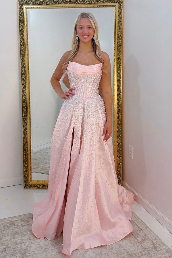 Woman in a pink, ruffle sparkly dress standing in front of a full-length mirror.