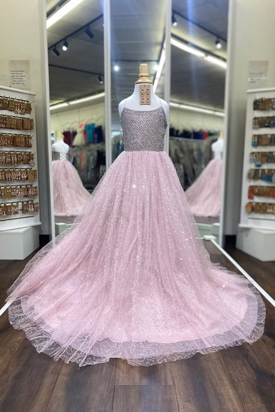 A pink ball gown with a sparkly silver beaded bodice and a voluminous tulle skirt, displayed on a mannequin in a retail store.