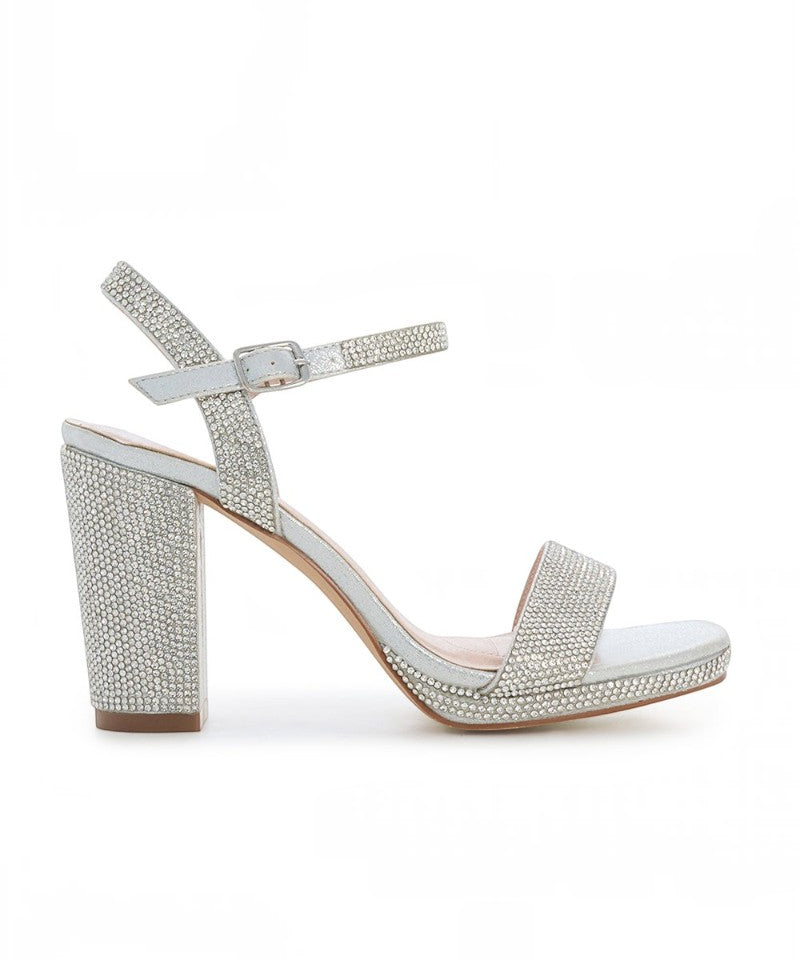 RSG Formals DeBlossom Morita silver shimmer block heel sandals with ankle strap and platform for formal occasions.