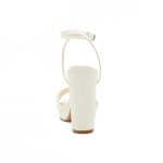 RSG Formals DeBlossom Jane white block heel sandals with an adjustable ankle strap, shown from the back view.