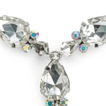 A silver-tone crystal necklace featuring large faceted marquise-cut clear rhinestones and smaller round iridescent crystals, shown on a plain white background.